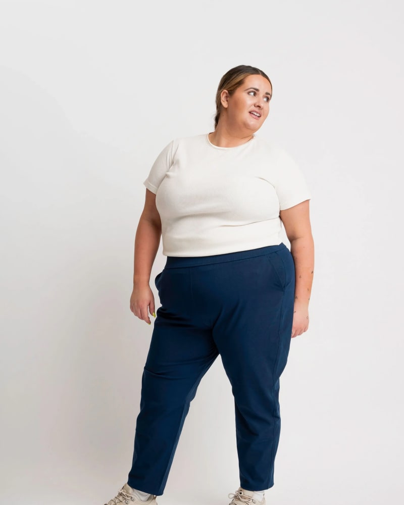 Front of a model wearing a size XL open air pant (28") in navy by alder apparel. | dia_product_style_image_id:319013